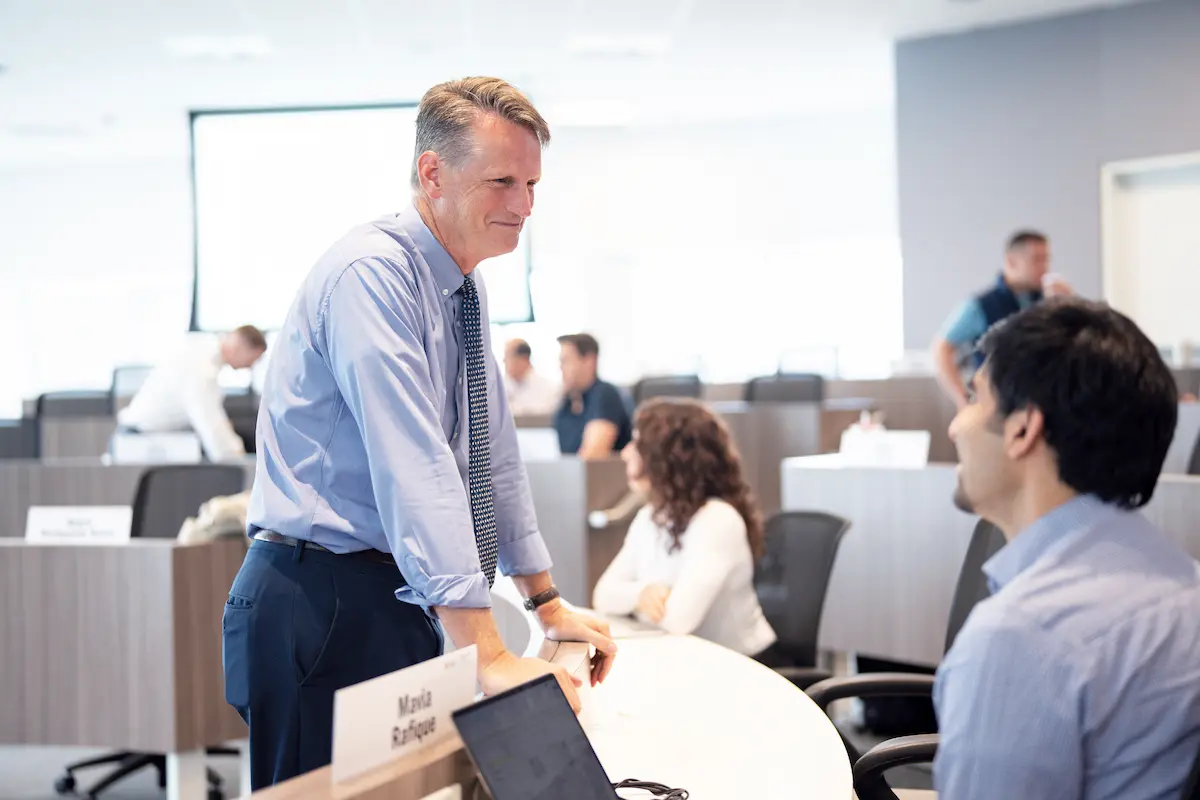 Two people having a conversation in a classroom